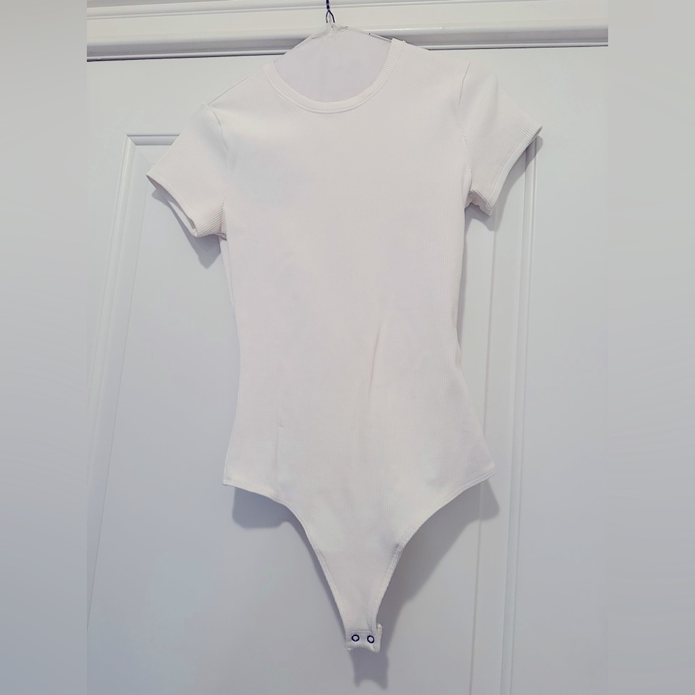 Womens Abercrombie ribbed white bodysuit size small with small black mark on it
